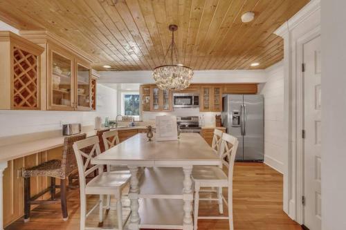 a kitchen with a white table and chairs at Blue Pearl Beach House Steps from Beach Access in Tybee Island