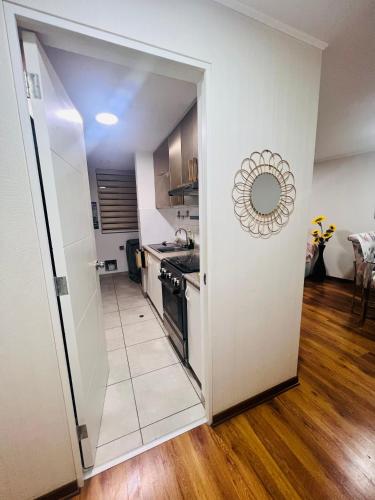 a kitchen with a door open to a living room at Pacific Apartamento Surco in Lima