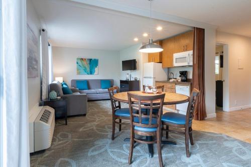 a kitchen and living room with a table and chairs at San Clemente Inn in San Clemente