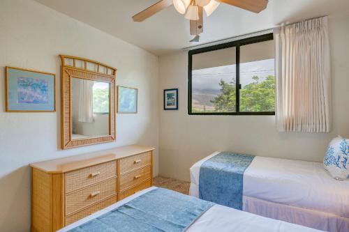 a bedroom with two beds and a mirror and a dresser at Kanai A Nalu 310 in Wailuku