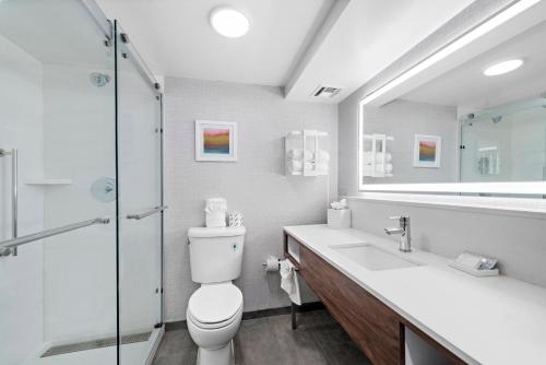 a bathroom with a toilet and a sink and a shower at Hampton Inn Los Angeles Airport in Los Angeles