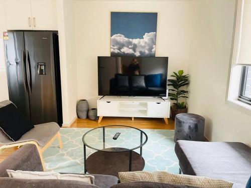 a living room with a large flat screen tv at D111 Special Melbourne retreat in Braybrook