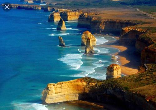 an aerial view of the apostles of the great ocean road at D111 Special Melbourne retreat in Braybrook