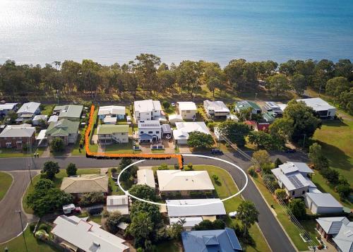 an aerial view of a city with houses and the ocean at Sandy Paws - Burrum Heads- Walk to Beach -3BR- Aircon-Pool table in Burrum Heads