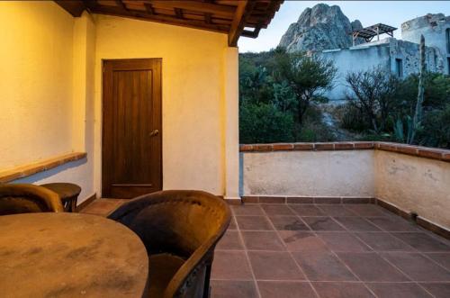 a room with a table and chairs and a door at Centenario Los Arroyitos in Bernal