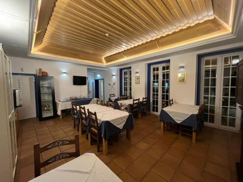 a restaurant with tables and chairs and a ceiling at LOUSAL TENTS Grandola in Lousal