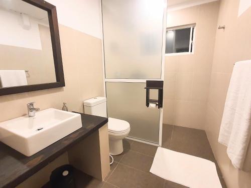 a bathroom with a sink and a toilet at The Backwaters Lodge in Wilpattu