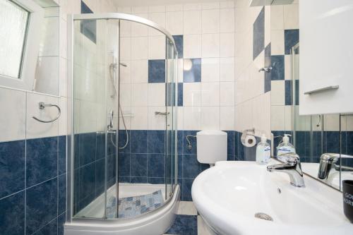 a bathroom with a shower and a sink and a toilet at Seaside holiday house Zubovici, Pag - 22859 in Zubovići