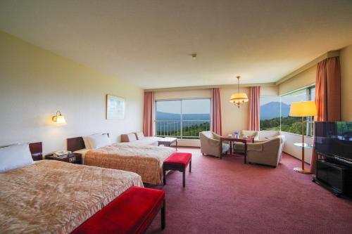 Ein Bett oder Betten in einem Zimmer der Unterkunft Tsumagoi Prince Hotel