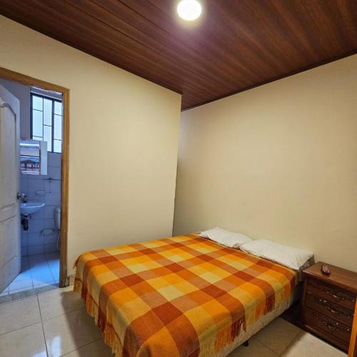 a bedroom with a bed in a room with a bathroom at Casa Hotel Bonita in Pacho