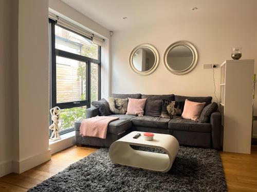 a living room with a couch and a coffee table at Omega Terrace, Luxury Modern Interior, Located Close To Alexandra Palace in London