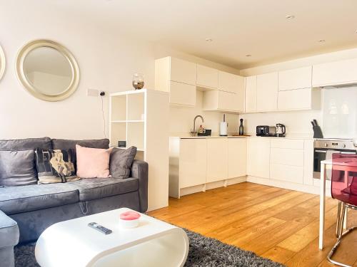 a living room with a couch and a table at Omega Terrace, Luxury Modern Interior, Located Close To Alexandra Palace in London