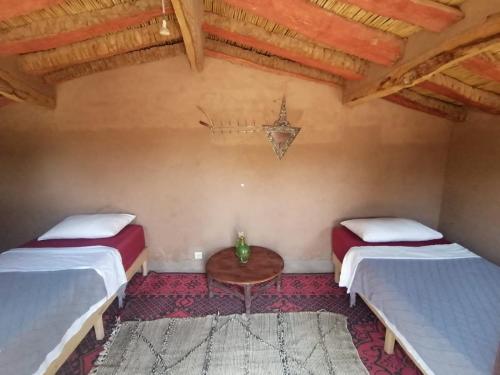 Postel nebo postele na pokoji v ubytování Auberge la Palmeraie