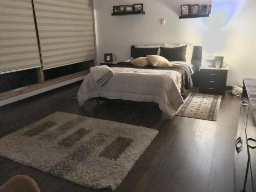 a bedroom with a large bed and a rug at Athos Hotel Boutique in Bolivia