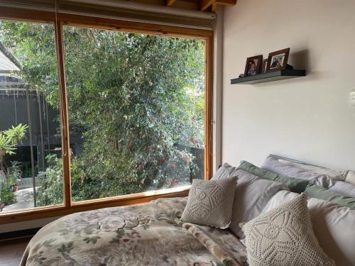 a living room with a large window and a couch at Athos Hotel Boutique in Bolivia