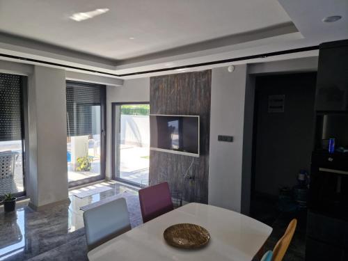 a dining room with a table and chairs and a window at Villa Miray in Belek