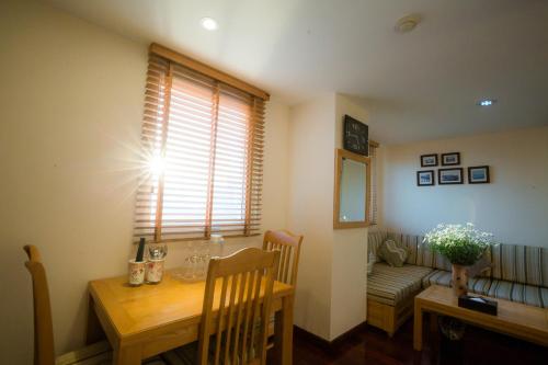 a dining room with a table and a window at Hai Phong Tower - Apartment & Hotel in Hai Phong