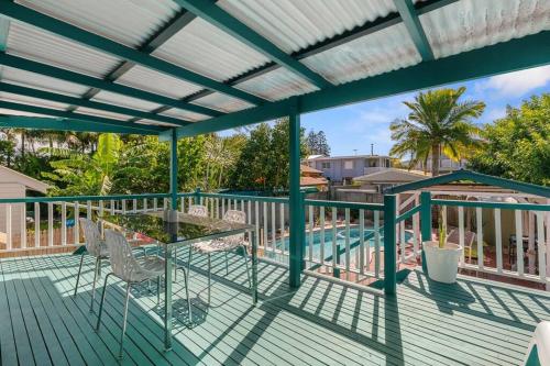 a deck with chairs and a table and a pool at Kitesurfer in Scarborough