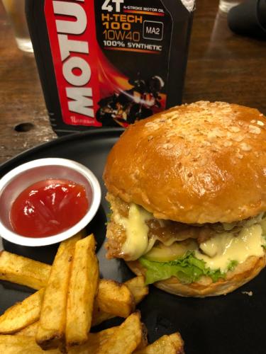a plate with a sandwich and french fries and ketchup at Cafe Moto Hostel in Puerto Princesa City