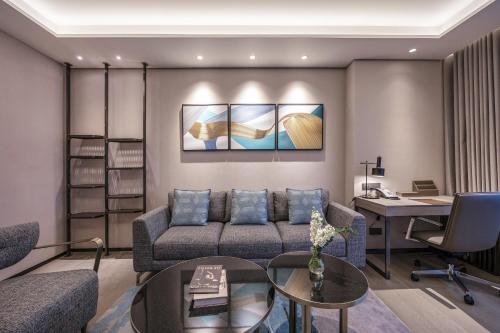 a living room with a couch and a desk at Fraser Residence Hanoi in Hanoi