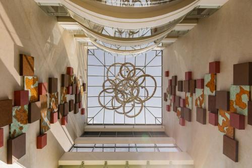 a hallway with art on the walls of a building at Crowne Plaza Nairobi Airport by IHG in Nairobi