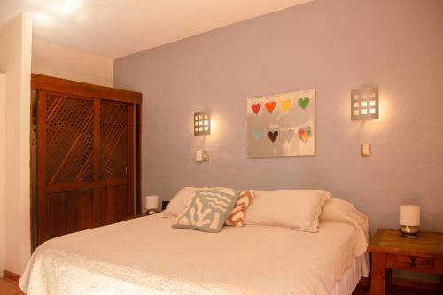 a bedroom with a bed with two pillows on it at Condominio con Alberca en la Zona Hotelera Puerto Vallarta in Puerto Vallarta