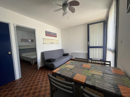 - un salon avec une table à manger et un canapé dans l'établissement Spacieux T2 pour 4p avec terrasse, parking privé à 400m de la plage, quartier animé, animaux OK - FR-1-799-9, au Barcarès