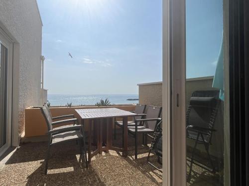 une table et des chaises sur un balcon avec vue sur l'océan dans l'établissement T2 au Barcarès avec terrasse et parking, proche commerces - FR-1-799-12, au Barcarès