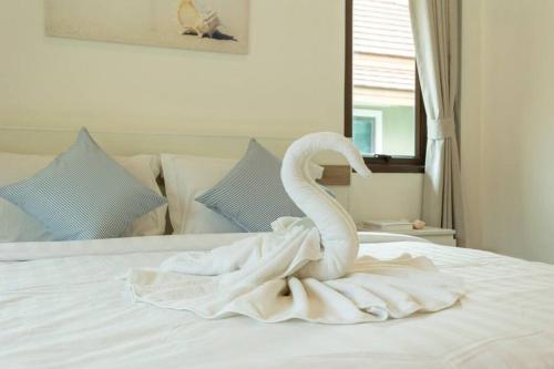 a white swan sitting on top of a bed at Center Stay from Patong Bangla Walking Street V107 in Patong Beach