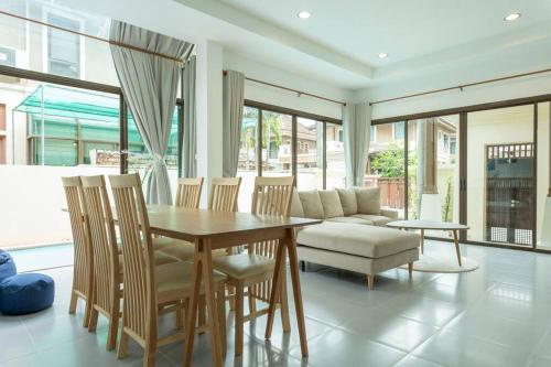 a dining room with a table and chairs and a couch at Center Stay from Patong Bangla Walking Street V107 in Patong Beach