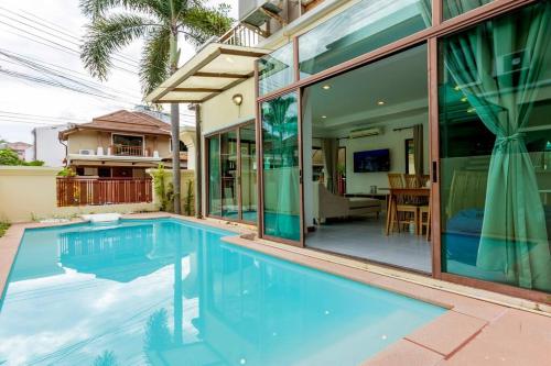 a swimming pool in front of a house at Center Stay from Patong Bangla Walking Street V107 in Patong Beach