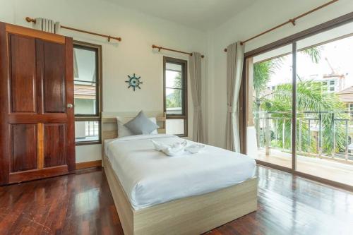a bedroom with a white bed and a large window at Center Stay from Patong Bangla Walking Street V107 in Patong Beach