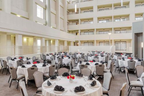 a banquet hall with tables and chairs and a projection screen at Crowne Plaza Indianapolis-Airport by IHG in Indianapolis