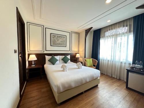 a hotel room with a bed and a window at Elliebum Boutique Hotel in Chiang Mai