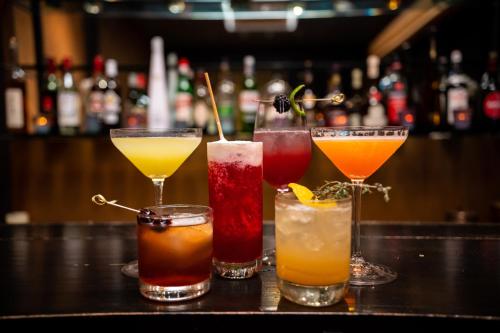 a group of four cocktails sitting on a bar at 1850 Hotel Boutique in Guanajuato