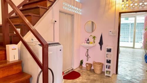 a laundry room with a washer and a sink at Baan YentaFo - Pink House 2nd floor in Chinatown
