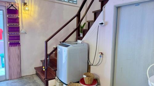 a staircase with a heater in a room with a stair case at Baan YentaFo - Pink House 2nd floor in Chinatown