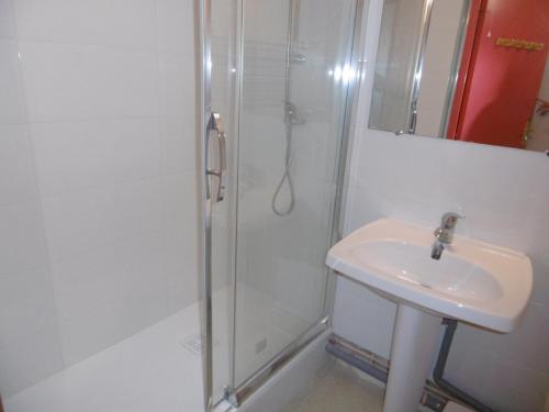 une salle de bain blanche avec une douche et un lavabo dans l'établissement Sète: Apt 25m², 4pers, Clim, Terrasse, Parking - FR-1-472-205, à Sète