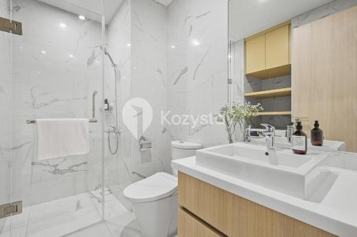 a bathroom with a sink and a toilet and a shower at Altin by Kozystay - TB Simatupang in Jakarta