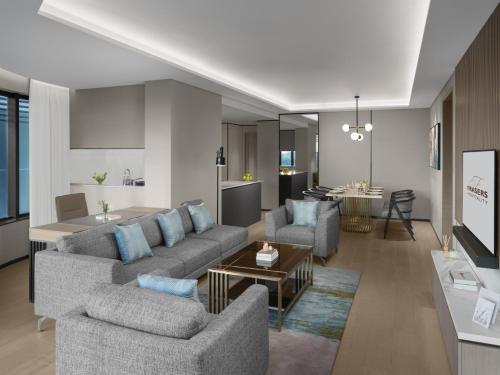 a living room with two couches and a kitchen at Fraser Residence Hanoi in Hanoi