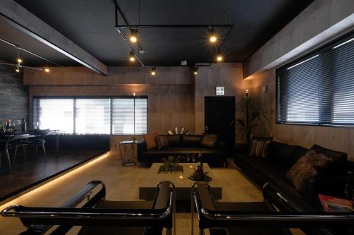 a living room with a couch and a table at 国際通りまで車で5分 那覇空港まで車で8分 最大15名 As bld in Makishimachi