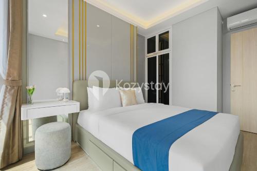 a bedroom with a white bed and a window at Altin by Kozystay - TB Simatupang in Jakarta