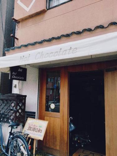 a bicycle is parked outside of a store at Meek House 难波6分钟车程&最近电车站1分钟&奈良京都一小时&大型超市旁&安静生活区 in Osaka