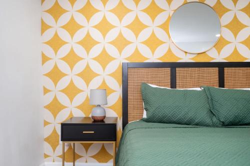 a bedroom with a bed and a mirror on a wall at Chic 2-Bed Haven with Vibrant Décor in SE Atlanta in Atlanta