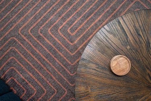 a coin sitting on the floor next to a rug at Chic 2-Bed Haven with Vibrant Décor in SE Atlanta in Atlanta