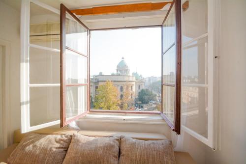 an open window with a view of a city at Apartments City Hall in Belgrade