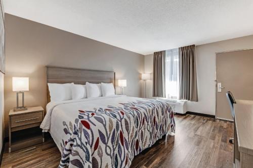 a hotel room with a bed and a window at Red Roof Inn & Suites Wilkesboro in Wilkesboro