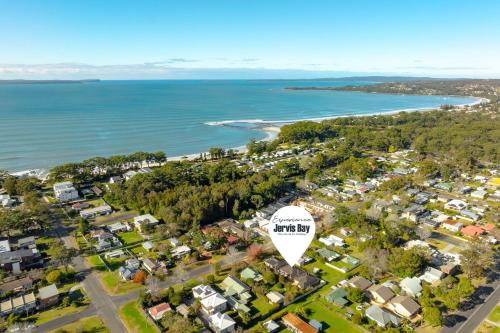 an aerial view of a suburb with houses and the ocean at Coral Villa by Experience Jervis Bay in Huskisson