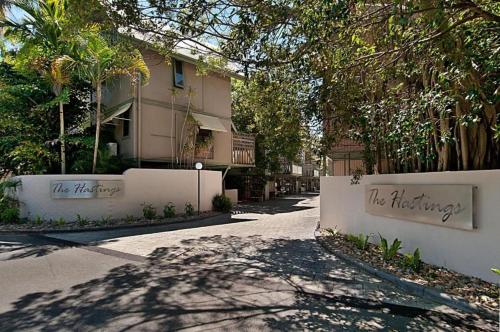 a street in front of a building with the words we whispering at The Hastings Beach Houses in Noosa Heads