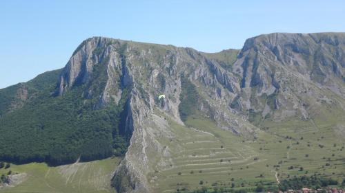 a mountain with a terraced field in front of it at Long Rock Chalets in Rimetea